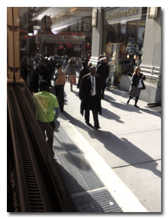 A street full of many passing shadows