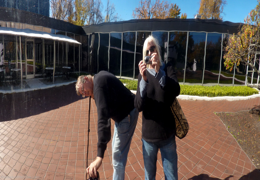 Two tourist shooting themselves in a reflection.
