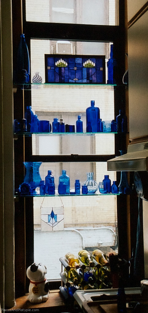New York City: I loved Sukey's blue glass so much I started accumulating various glass objects both old and new  and putting them in my windows. This is from our kitchen window on West 81st Street.