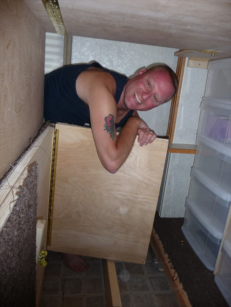 Ryan is helping to fold the floor in the camper's workroom.