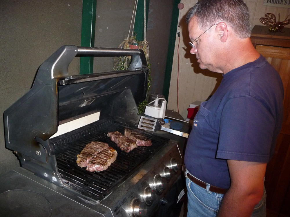 Jon grills the steaks.